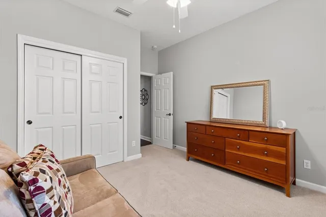 a bathroom with a granite countertop sink toilet and mirror