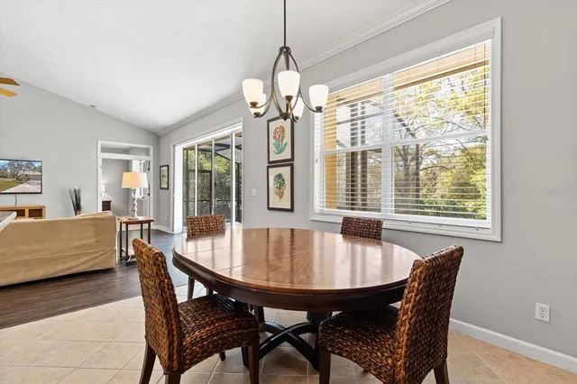 a dining room with furniture window and wooden floor