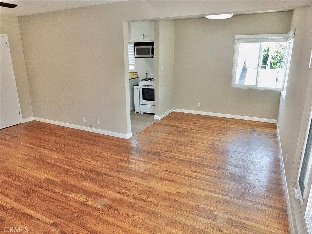 1808 East Appleton Street, Unit 7 Long Beach, CA 90802 - Photo 16 of 44 an empty room with wooden floor and windows