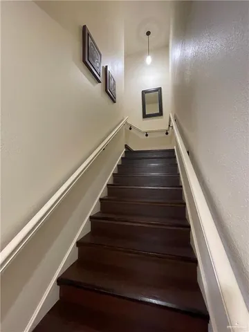 a spacious bedroom with a bed and wooden floor