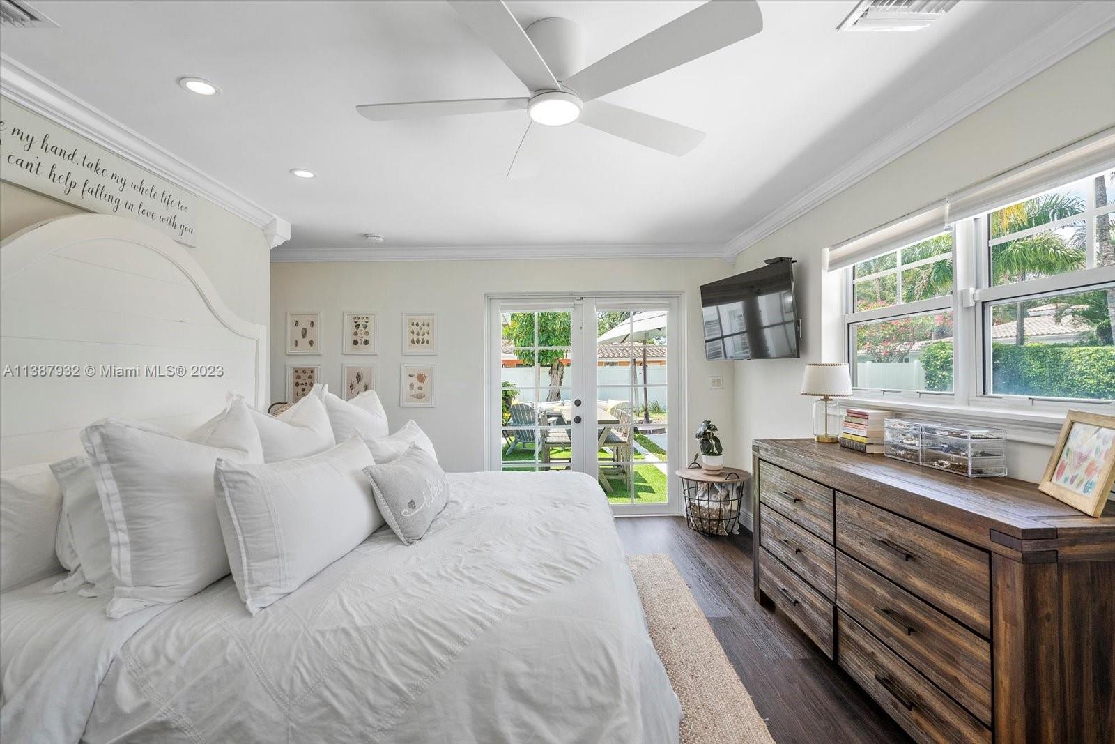 2533 Northeast 21st Terrace Lighthouse Point, FL 33064 - Photo 22 of 45 a bedroom with furniture and a large window