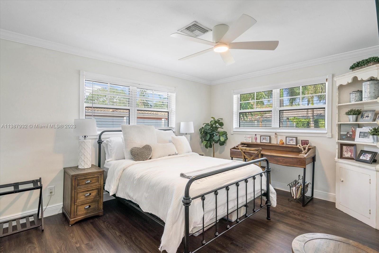 2533 Northeast 21st Terrace Lighthouse Point, FL 33064 - Photo 24 of 45 a bedroom with a bed a bookshelf and a window