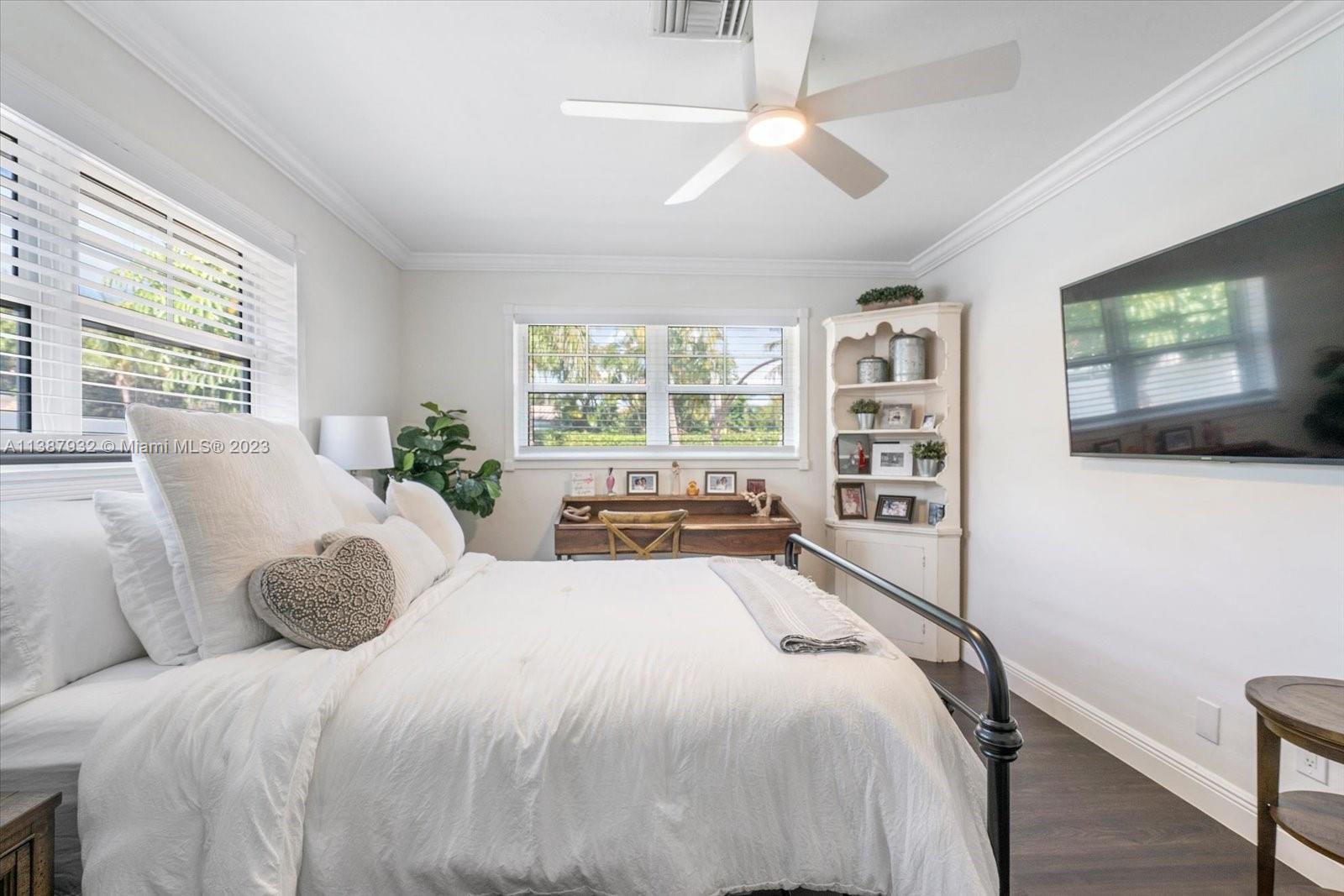 2533 Northeast 21st Terrace Lighthouse Point, FL 33064 - Photo 25 of 45 a bedroom with a large bed and a flat screen tv