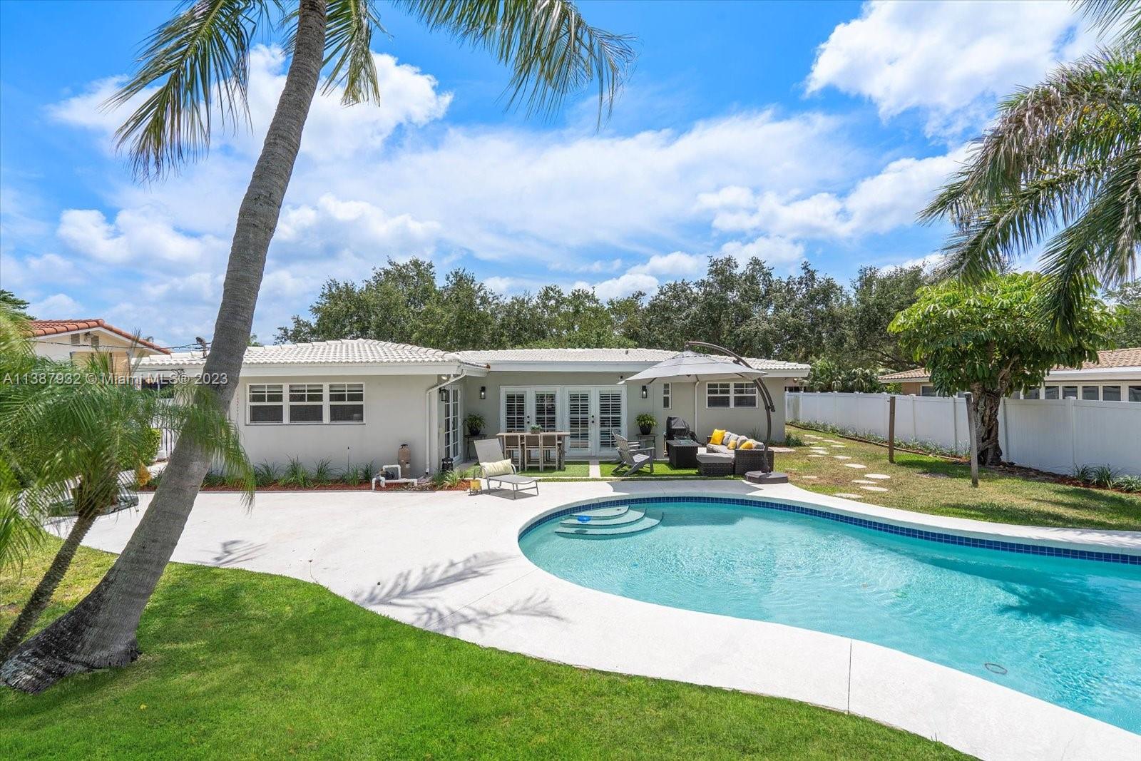 2533 Northeast 21st Terrace Lighthouse Point, FL 33064 - Photo 34 of 45 a view of a house with swimming pool and sitting area