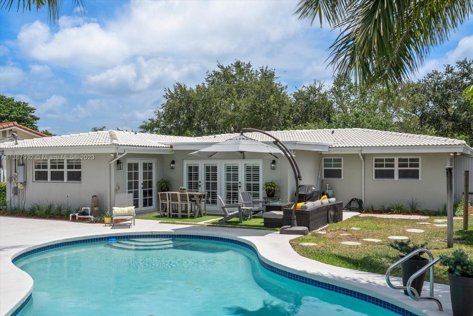 2533 Northeast 21st Terrace Lighthouse Point, FL 33064 - Photo 37 of 45 a view of a house with swimming pool and sitting area