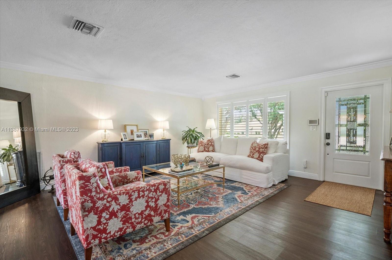 2533 Northeast 21st Terrace Lighthouse Point, FL 33064 - Photo 4 of 45 a living room with furniture rug and wooden floor