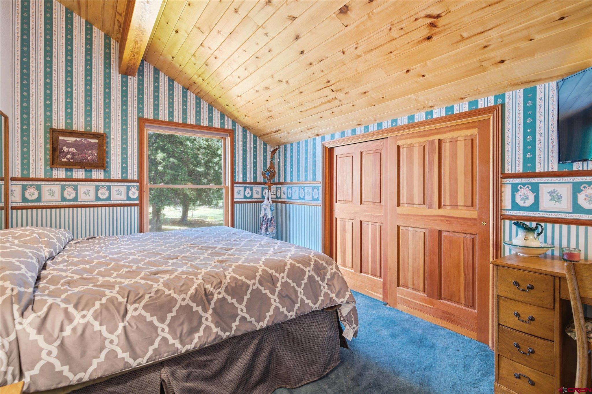 197 Hummingbird Way Bayfield, CO 81122 - Photo 23 of 44 a bedroom with a bed closet and a large window