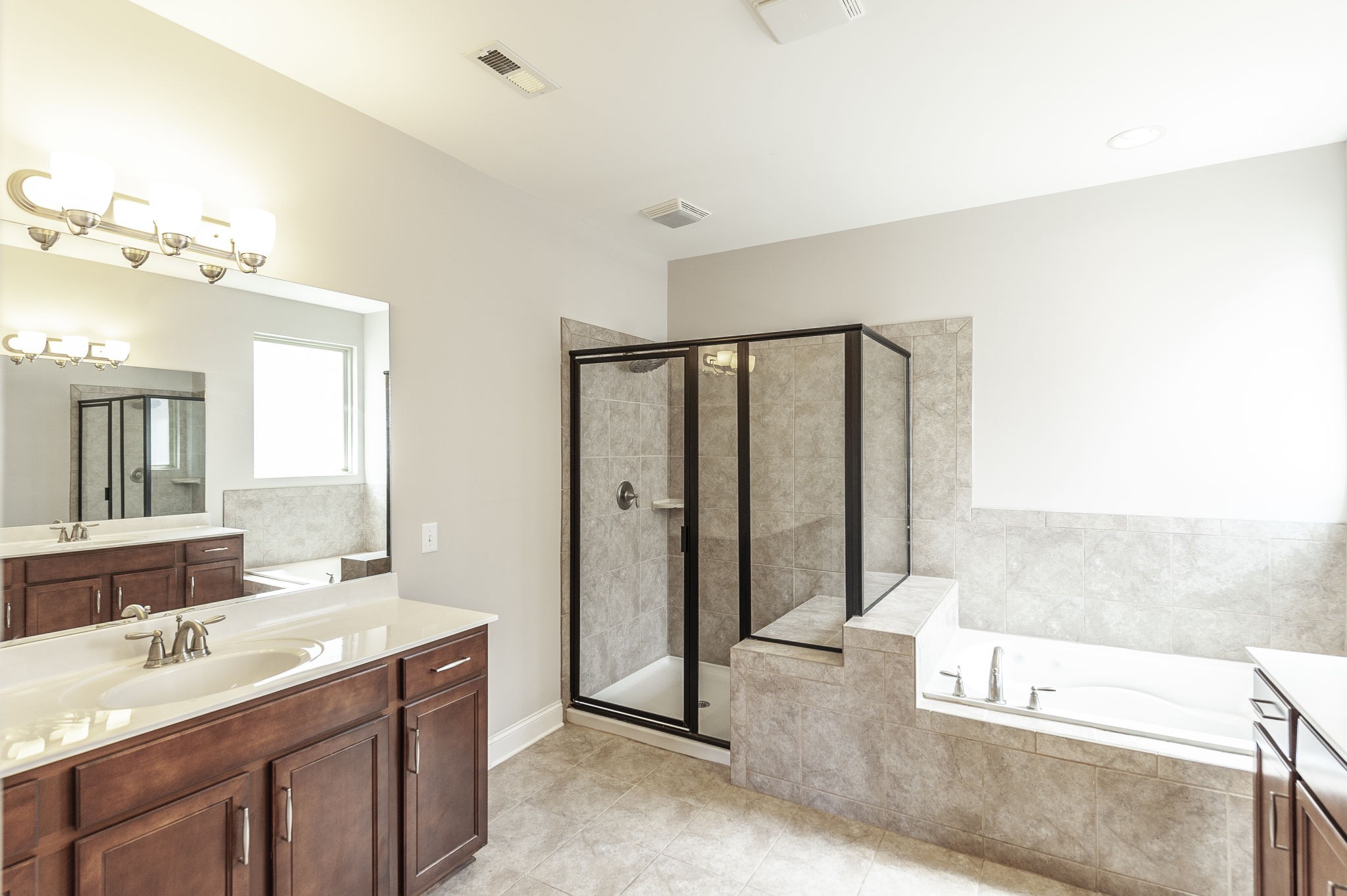 152 Ashcrest Point Hendersonville, TN 37075 - Photo 34 of 63 a spacious bathroom with a double vanity sink a mirror and a bathtub