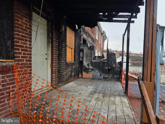 a view of a porch with a table and chairs