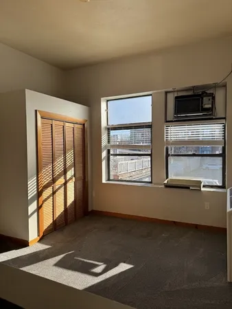 a view of an empty room with a window