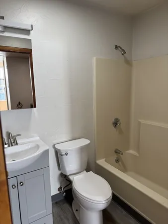 a white toilet sitting next to a bathroom sink