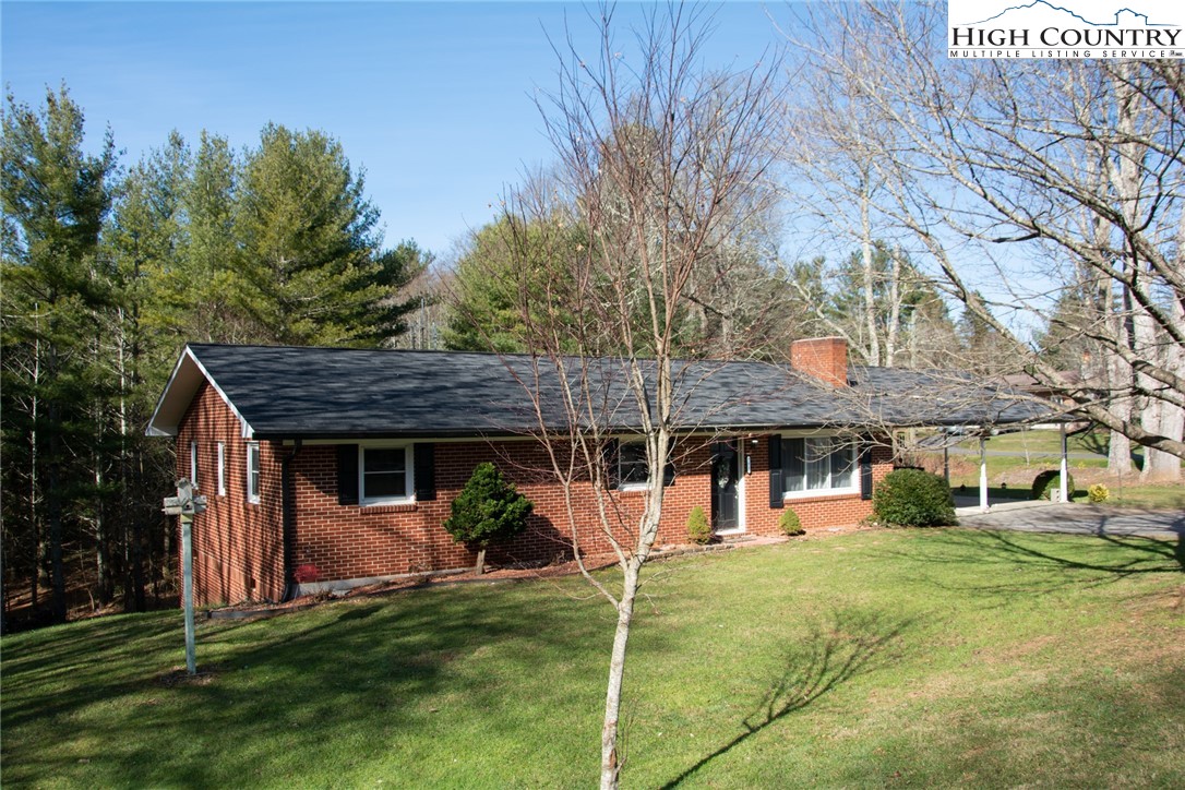 751 Cherry Hill Road Jefferson, NC 28640 - Photo 1 of 24 a front view of a house with a garden
