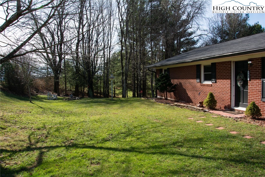 751 Cherry Hill Road Jefferson, NC 28640 - Photo 19 of 24 a view of a backyard with table and chairs and potted plants