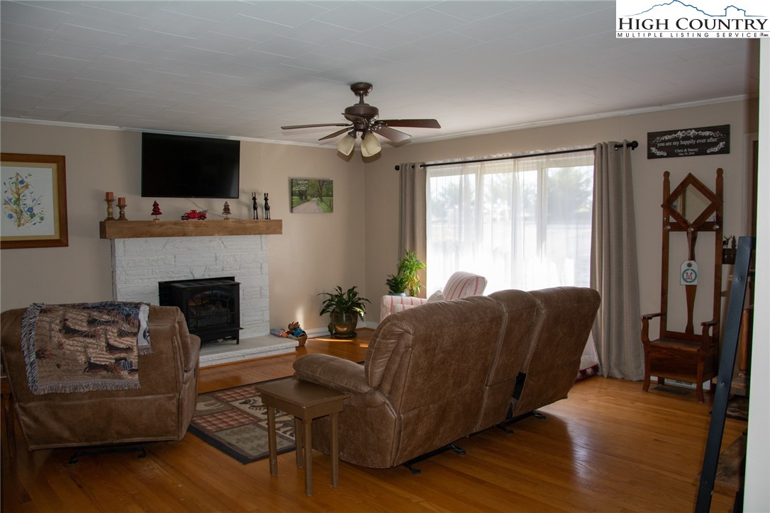 751 Cherry Hill Road Jefferson, NC 28640 - Photo 4 of 24 a living room with furniture a flat screen tv and a fireplace