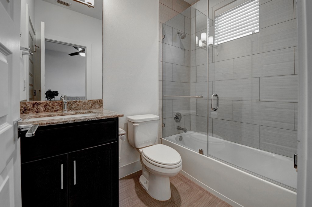 1300 Walnut Avenue, Unit B Austin, TX 78702 - Photo 6 of 15 a bathroom with a sink toilet a mirror and shower