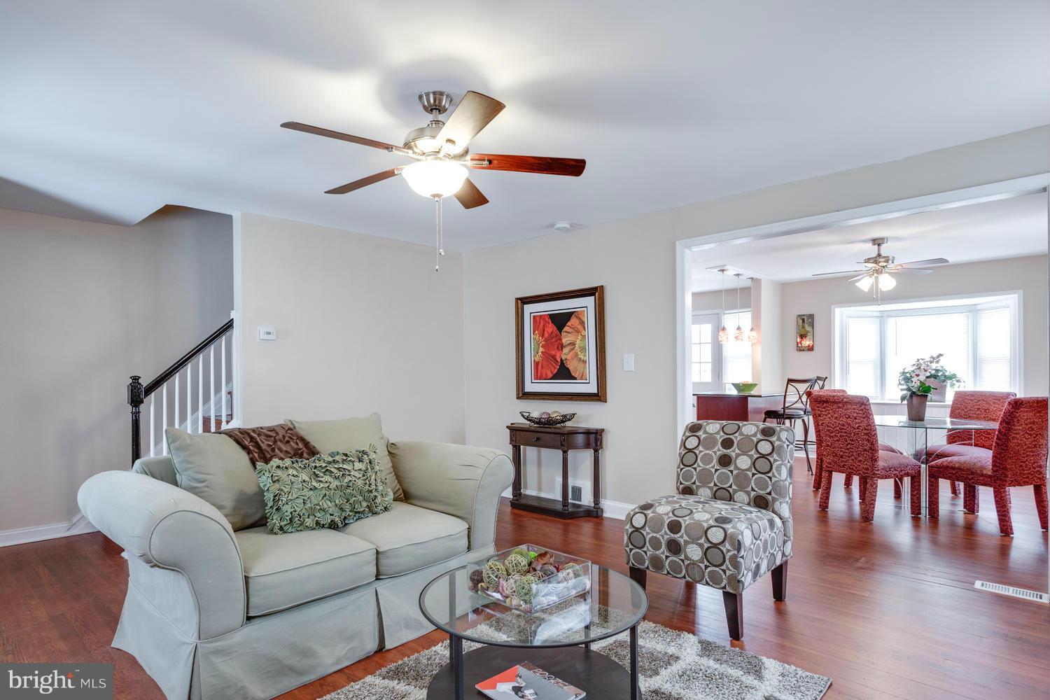 1701 Burnwood Road Baltimore, MD 21239 - Photo 1 of 30 a living room with furniture kitchen view and a wooden floor
