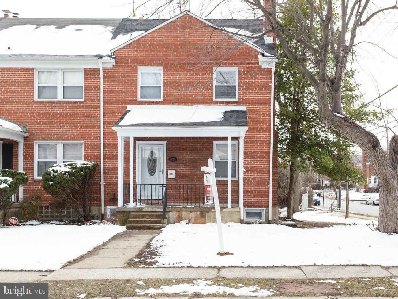 1701 Burnwood Road Baltimore, MD 21239 - Photo 2 of 30 a front view of a house with a yard
