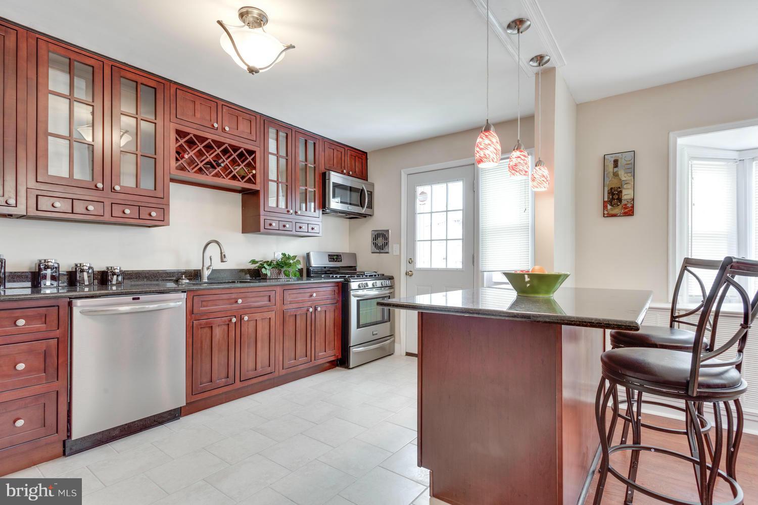 1701 Burnwood Road Baltimore, MD 21239 - Photo 10 of 30 a kitchen with granite countertop lots of counter top space and dining table