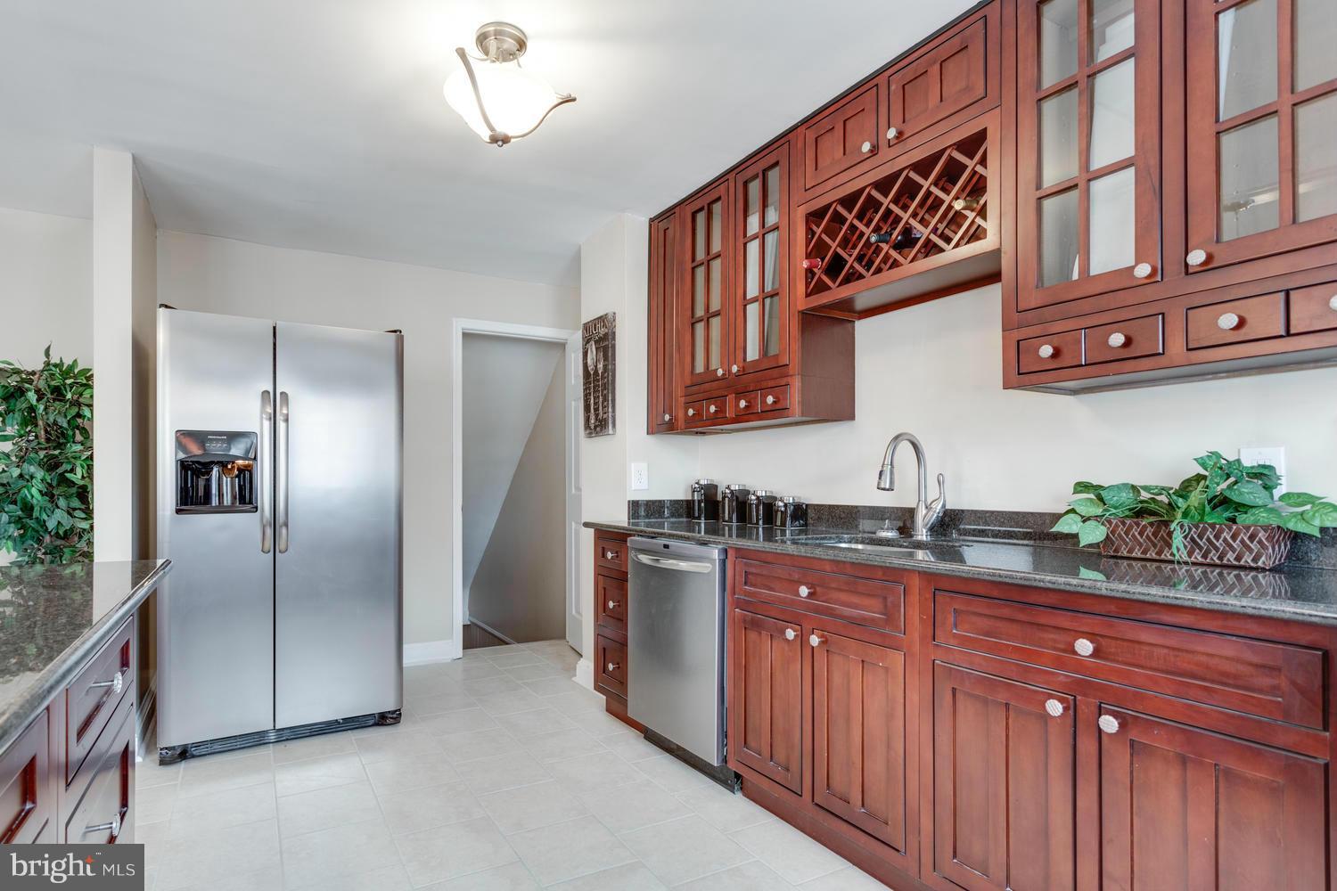 1701 Burnwood Road Baltimore, MD 21239 - Photo 11 of 30 a kitchen with stainless steel appliances granite countertop a refrigerator and a sink