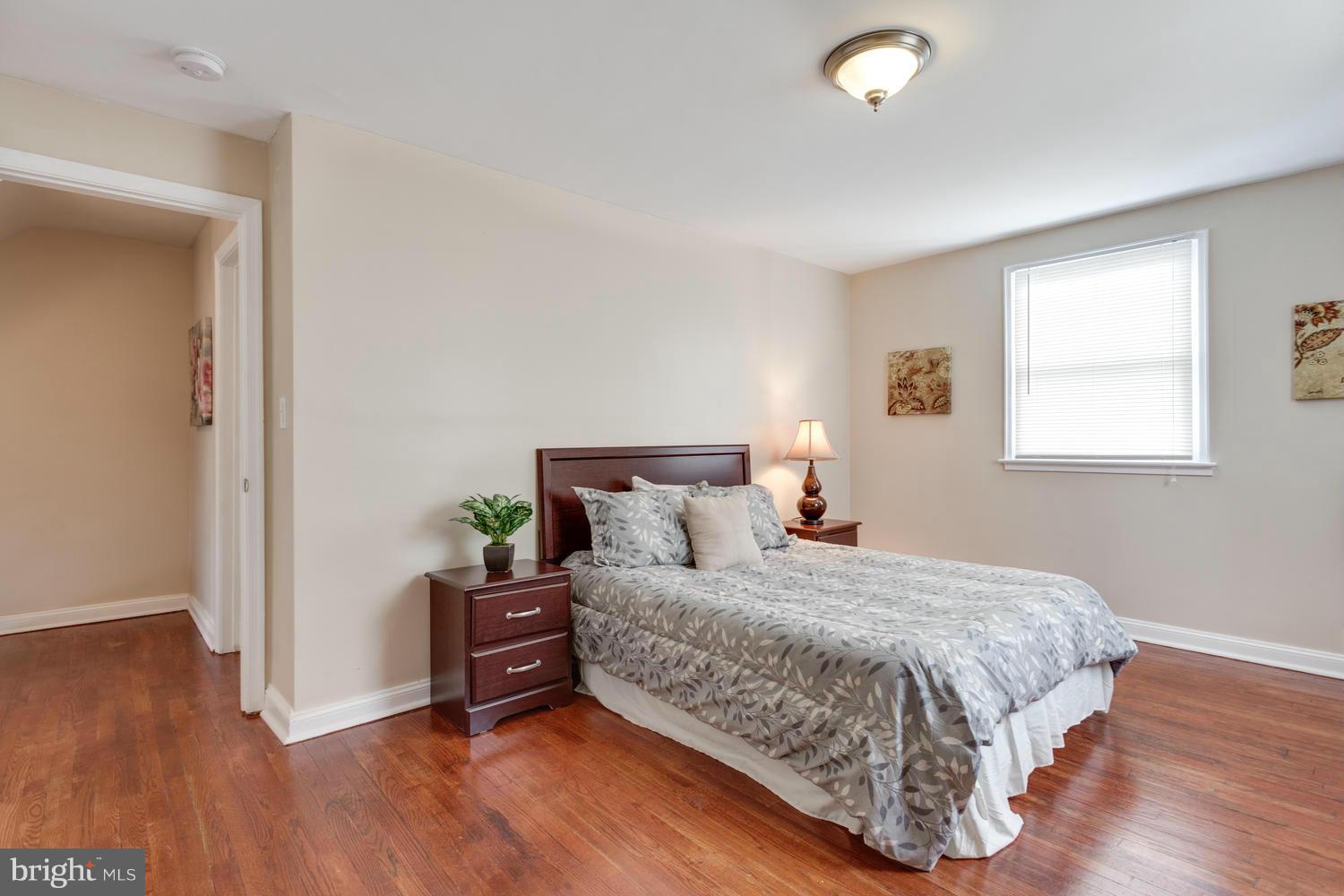1701 Burnwood Road Baltimore, MD 21239 - Photo 14 of 30 a bedroom with a bed and wooden floor
