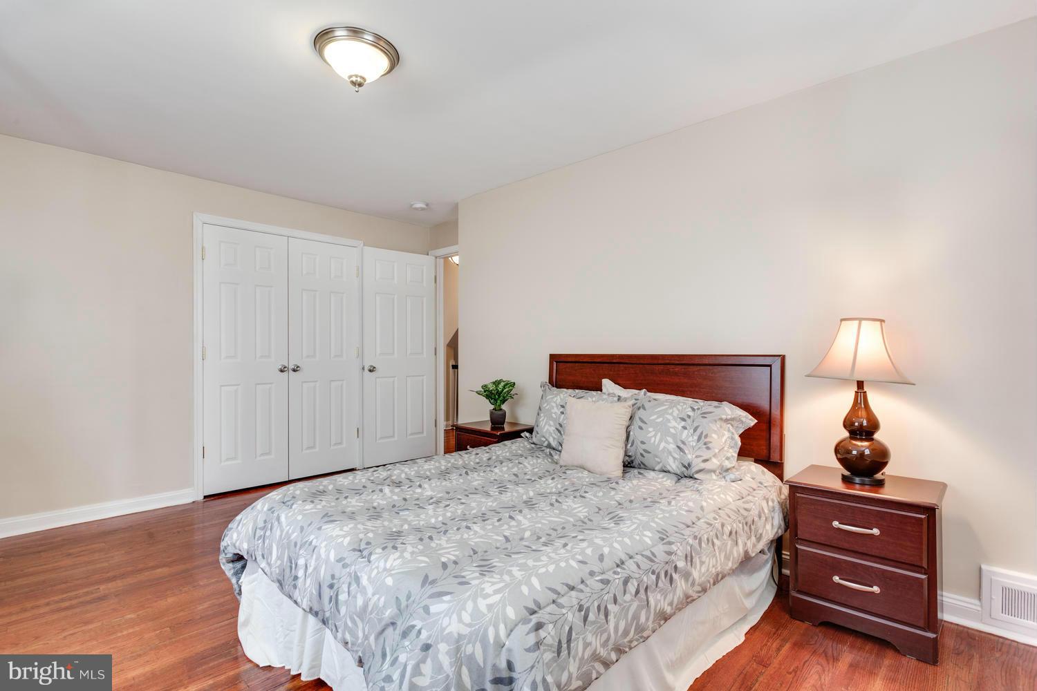 1701 Burnwood Road Baltimore, MD 21239 - Photo 15 of 30 a bedroom with a bed and a lamp