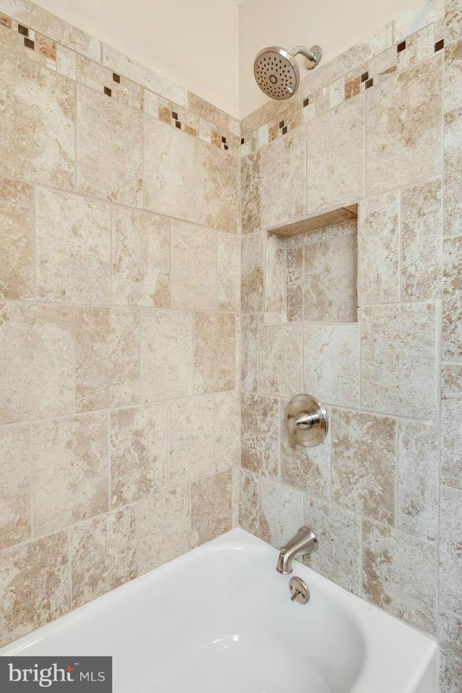 1701 Burnwood Road Baltimore, MD 21239 - Photo 17 of 30 a bathroom with a sink and a shower