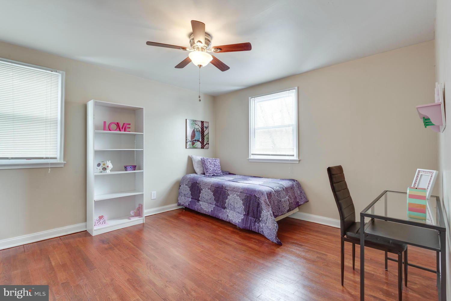 1701 Burnwood Road Baltimore, MD 21239 - Photo 18 of 30 a spacious bedroom with a bed and a chandelier
