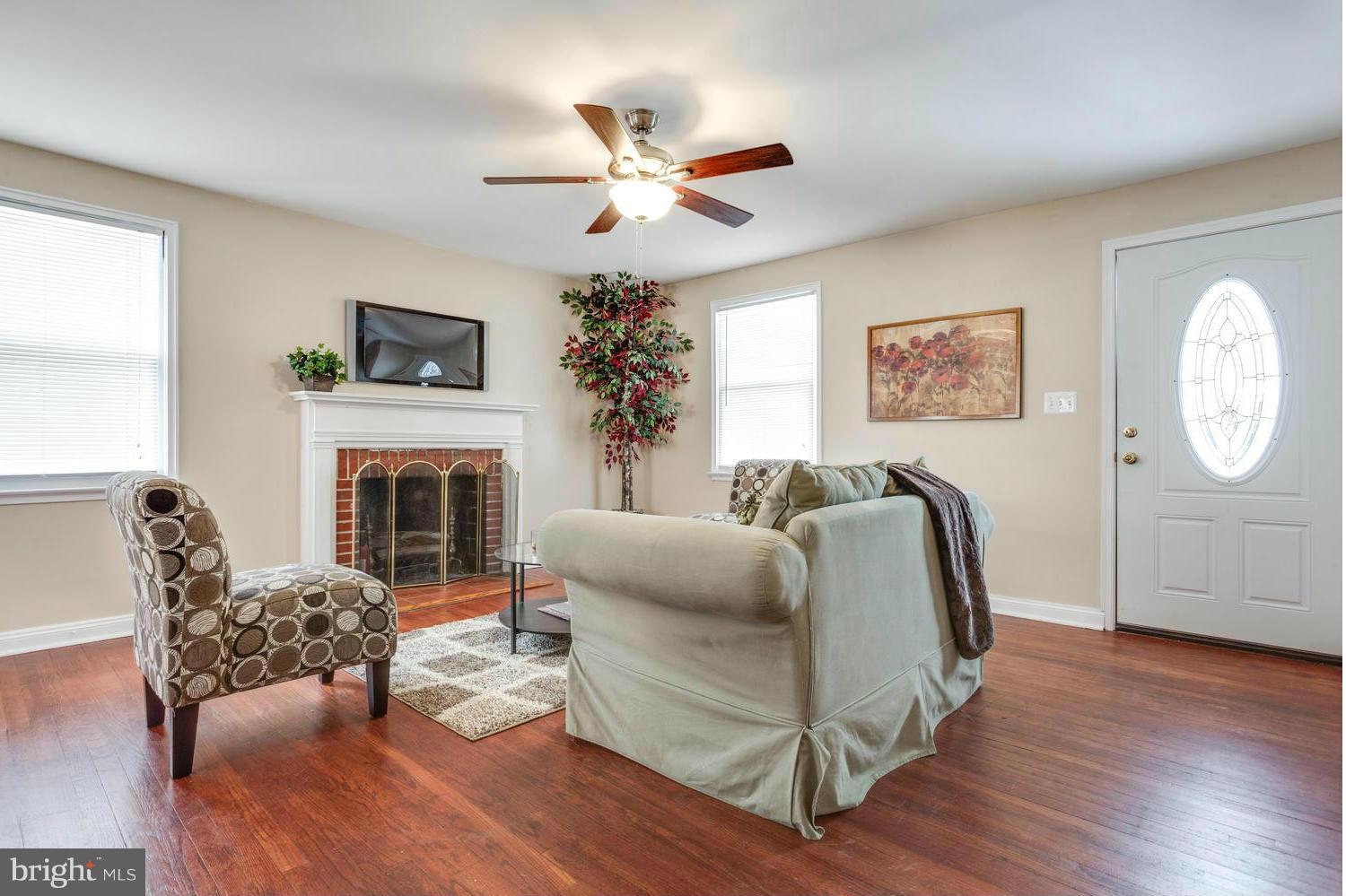1701 Burnwood Road Baltimore, MD 21239 - Photo 4 of 30 a living room with furniture a fireplace and a window
