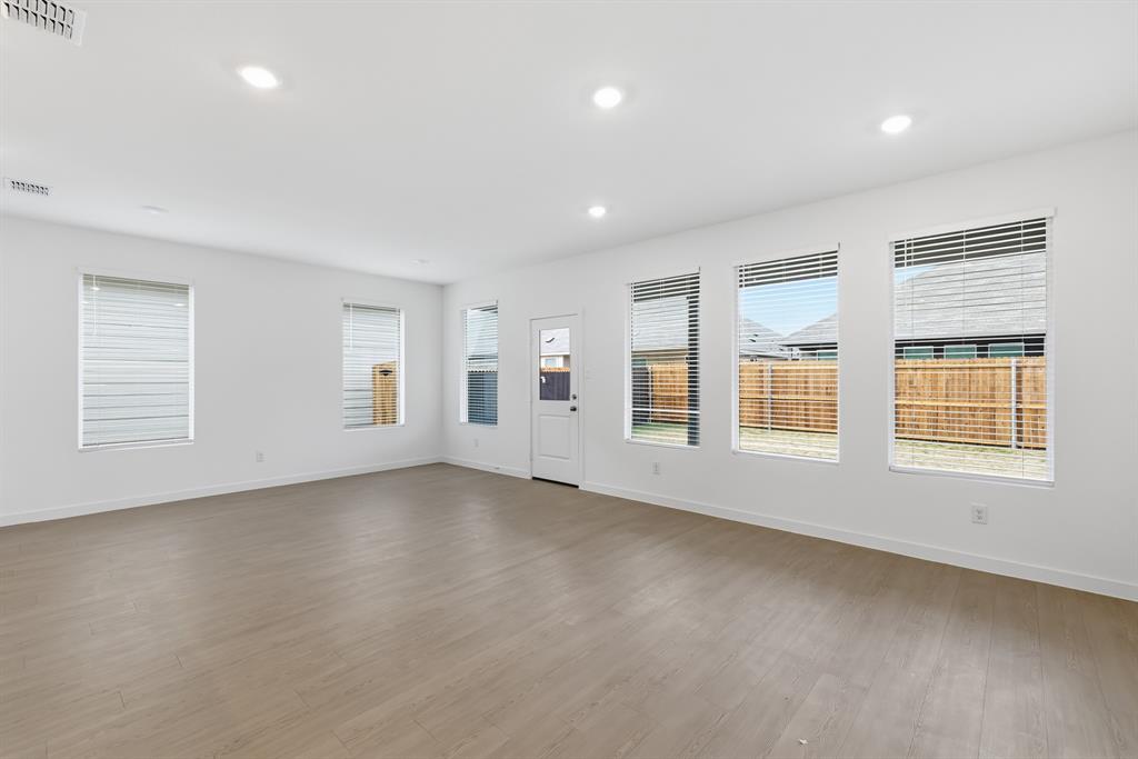 4916 Ascot Way Princeton, TX 75407 - Photo 17 of 39 an empty room with windows
