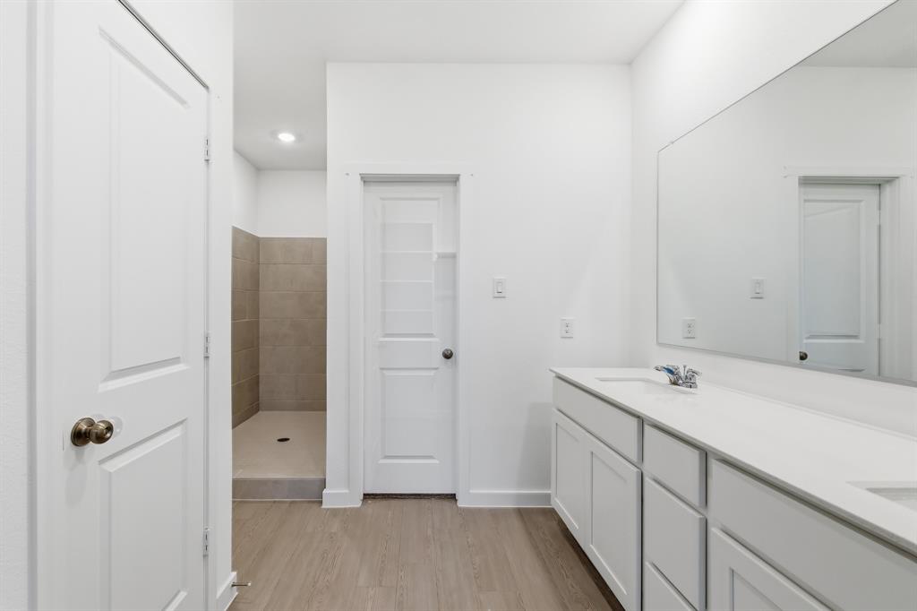 4916 Ascot Way Princeton, TX 75407 - Photo 20 of 39 a bathroom with a sink and a mirror