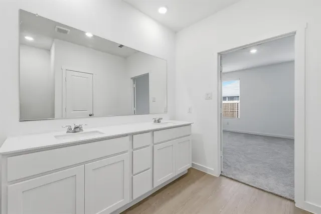 a bathroom with double sink and a mirror