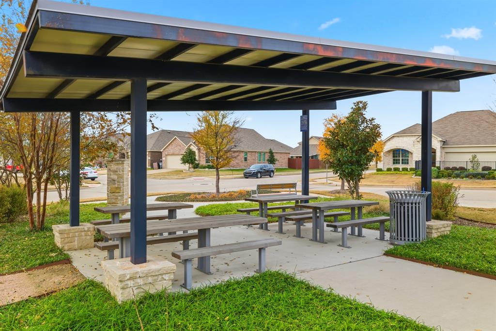 4916 Ascot Way Princeton, TX 75407 - Photo 38 of 39 a view of a patio with a table and chairs under an umbrella
