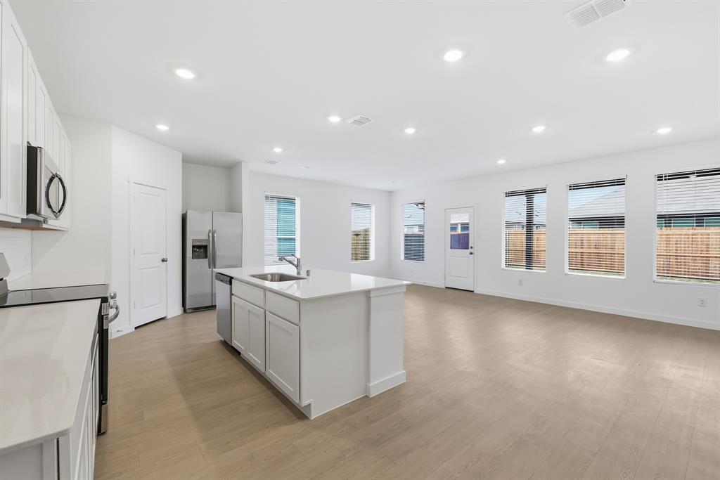 4916 Ascot Way Princeton, TX 75407 - Photo 5 of 39 a large kitchen with stainless steel appliances granite countertop a large counter top a stove and a refrigerator