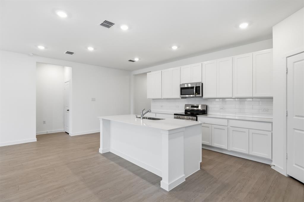 4916 Ascot Way Princeton, TX 75407 - Photo 10 of 39 a kitchen with stainless steel appliances granite countertop a stove and a refrigerator