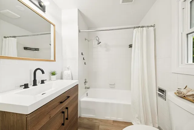 a bathroom with a sink mirror toilet and bathtub