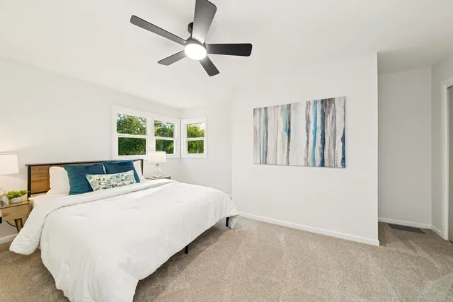 a bedroom with a large bed and a large window