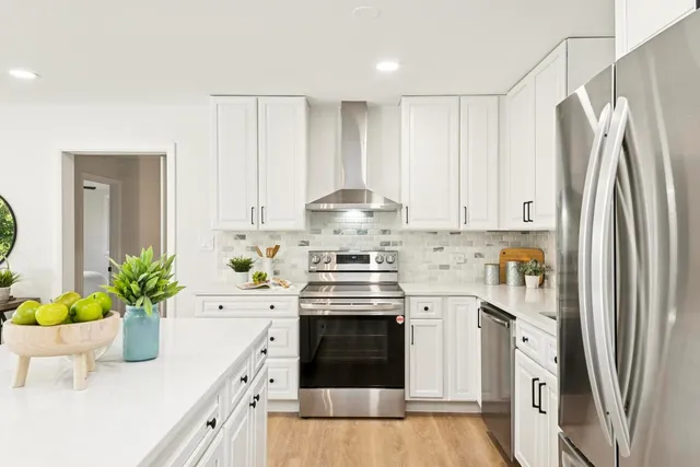 a kitchen with stainless steel appliances a white stove top oven and a refrigerator