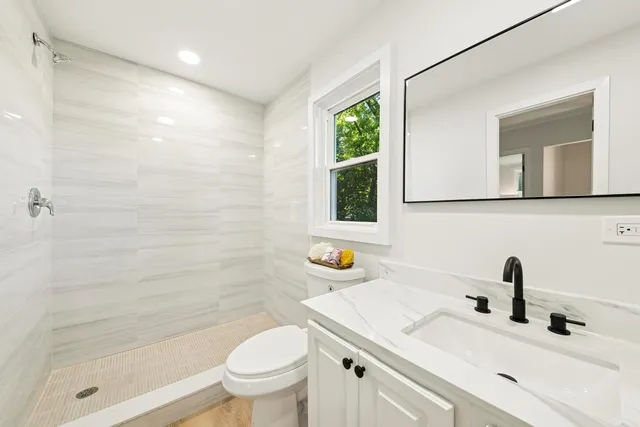 a bathroom with a sink toilet and shower