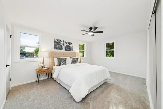 a bedroom with a large bed and a window