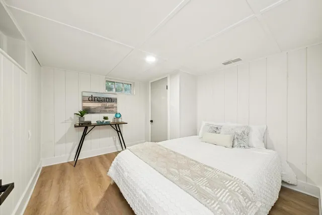 a bedroom with a bed and a chair