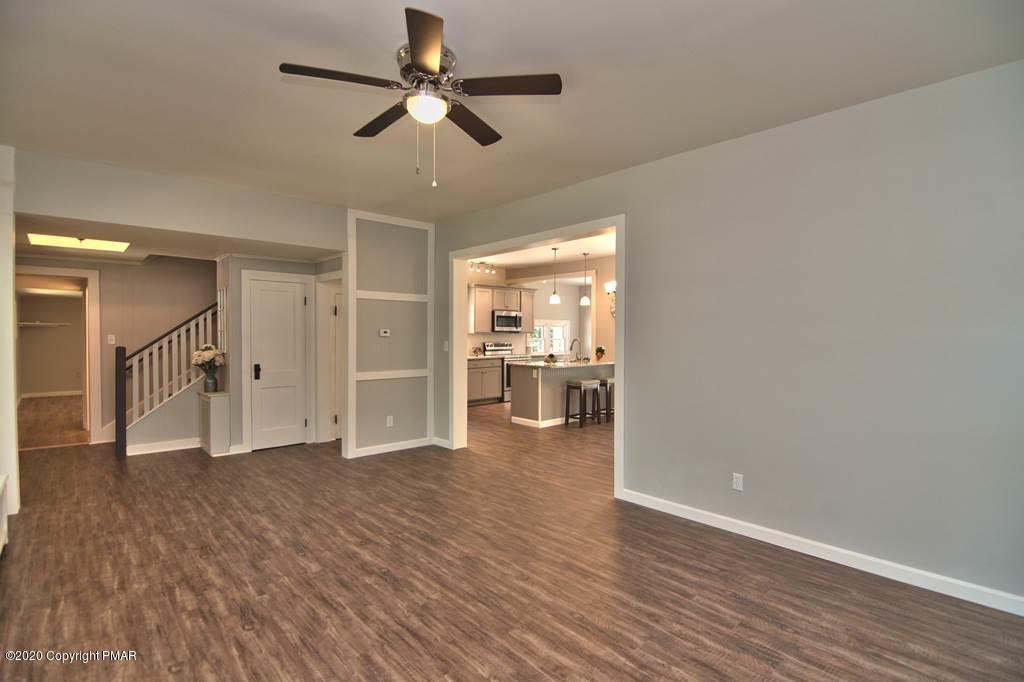 362 Upper Swiftwater Road Cresco, PA 18326 - Photo 11 of 87 a view of a livingroom with furniture wooden floor and a ceiling fan