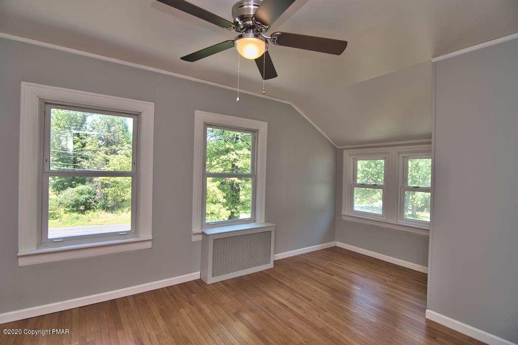 362 Upper Swiftwater Road Cresco, PA 18326 - Photo 42 of 87 a view of empty room with wooden floor and fan