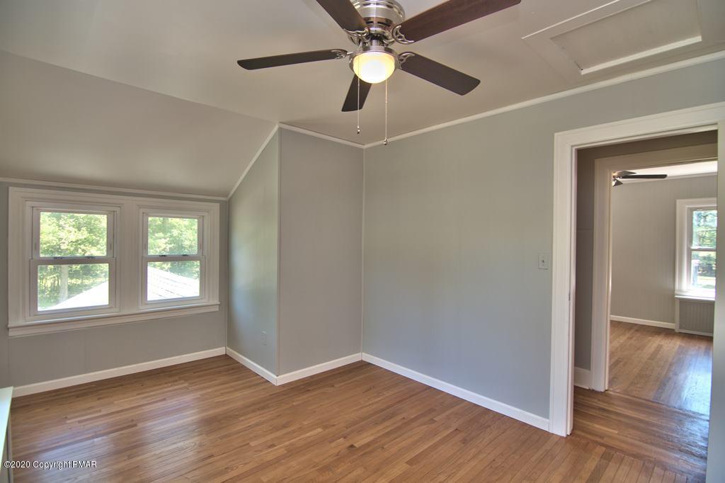 362 Upper Swiftwater Road Cresco, PA 18326 - Photo 44 of 87 an empty room with wooden floor chandelier fan and windows