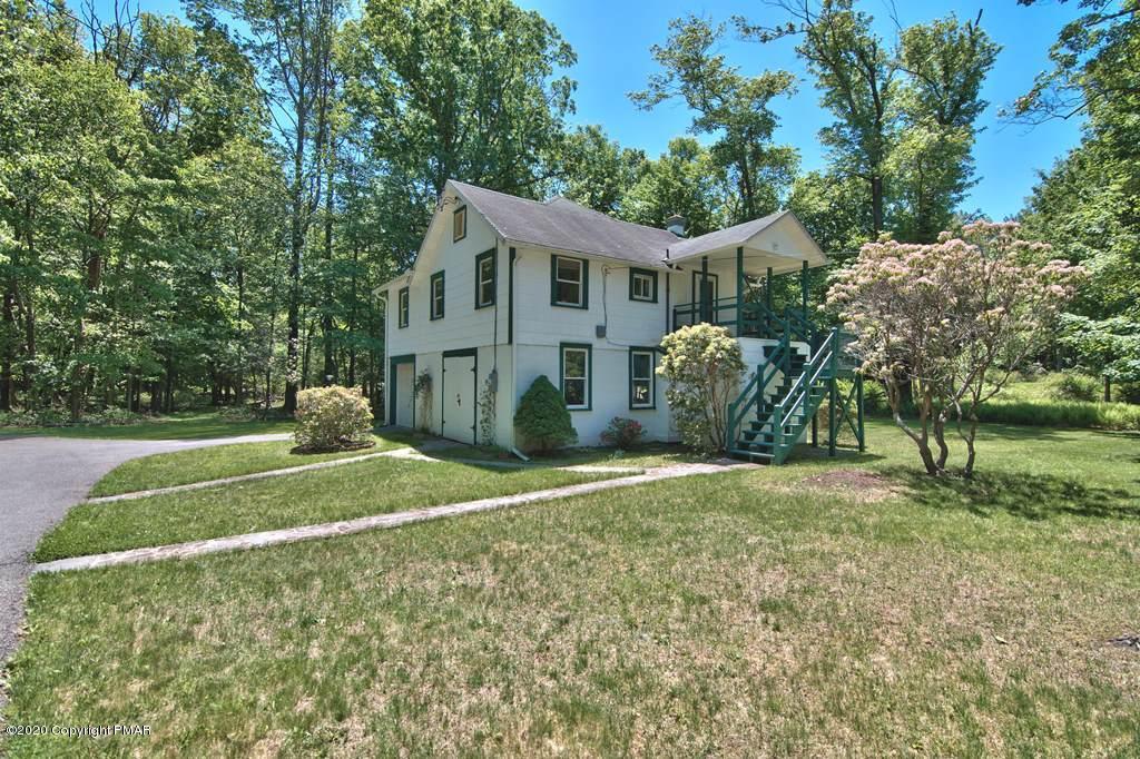 362 Upper Swiftwater Road Cresco, PA 18326 - Photo 63 of 87 a front view of a house with a yard and garage