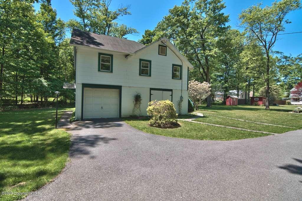 362 Upper Swiftwater Road Cresco, PA 18326 - Photo 66 of 87 a front view of a house with a yard and garage