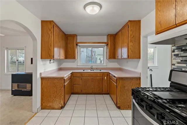 a kitchen with a stove a sink and a microwave
