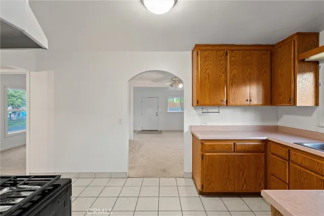 a view of a livingroom with wooden floor and a refrigerator