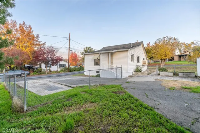 a view of a house with a yard and street view
