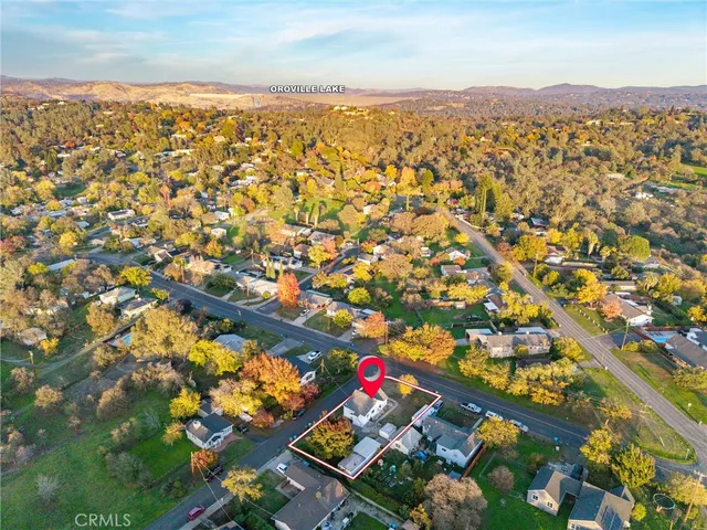 an aerial view of a house with a garden and swimming pool