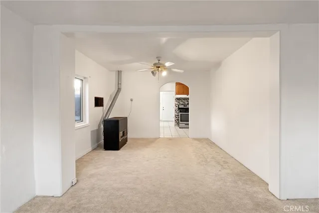 a view of a living room with furniture and a ceiling fan